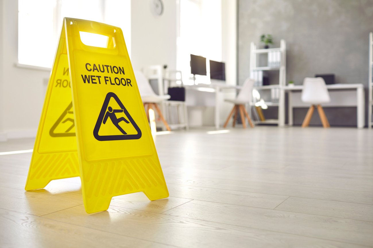 Sign Warning about Wet Floor Placed in the Office by a Commercial Cleaning Service