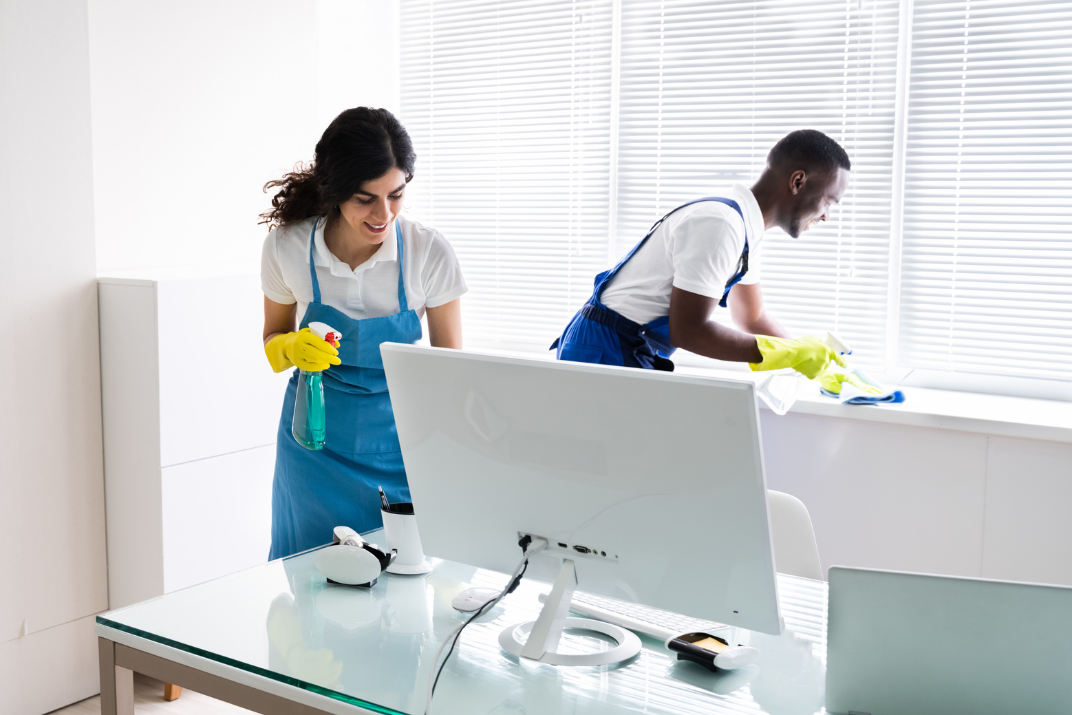 Male And Female Cleaners Cleaning Office